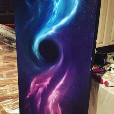 This is a space painting of a black hole sucking in the light of the stars. The light at the top of half of the painting is a bright blue while the light at the bottom half of the painting is a bright purple.